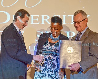 Dr. Sherri Harper Woods is handed her Campus Leadership award from YSU Provost VP Academic Affairs Martin Abraham as YSU President James P. Tressel stands with an award from the State of Ohio at the Diversity Leadership Recognition Dinner at Stambaugh Tyler Grand Ballroom on Thursday, March 22, 2018.

Photo by Scott Williams - The Vindicator