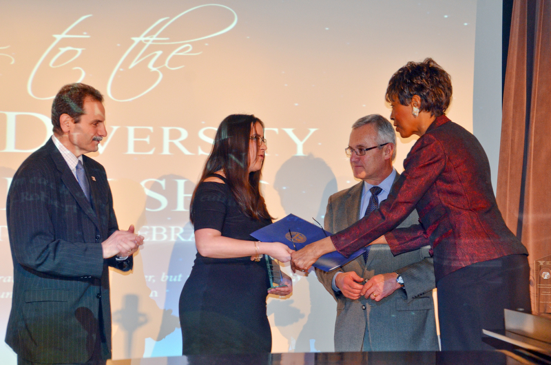Dr. Sylvia J. Imler, Associate Vice President/Chief Diversity Officer, Multicultural Affairs, hands Catherine Cooper, Leader of Tomorrow recipient, an recognition from the State of Ohio at the Diversity Leadership Recognition Dinner at Stambaugh Tyler Grand Ballroom on Thursday, March 22, 2018.  Cooper is standing between Martin Abraham, left, Provost VP Academic Affairs, and Youngstown State President James P. Tressel.

Photo by Scott Williams - The Vindicator