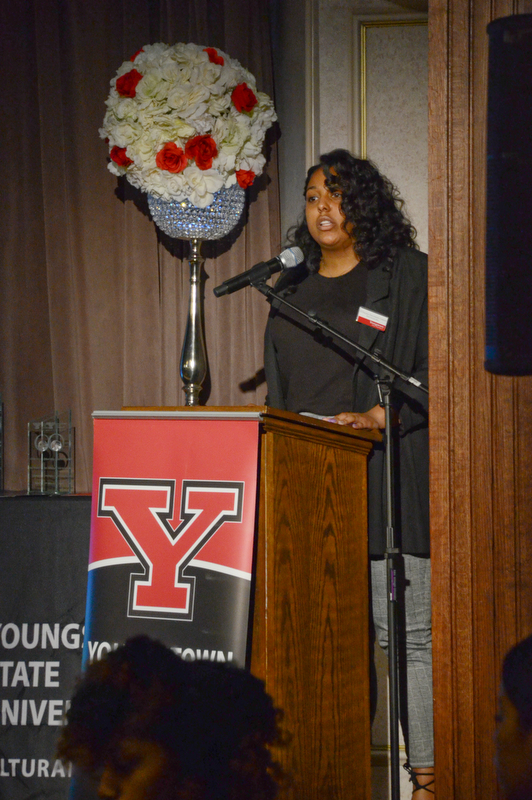 E'Dazjia Solomon-Green, marketing management major and 2nd year Navarro Executive Fellow, reads the poem "I AM Diversity" at the Diversity Leadership Recognition Dinner at Stambaugh Tyler Grand Ballroom on Thursday, March 22, 2018.

Photo by Scott Williams - The Vindicator