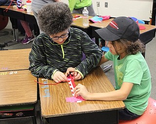 Neighbors | Abby Slanker.Two Hilltop Elementary School students in Marie Rupert’s third-grade class worked together to make a paracord bracelet for their economics lesson on March 14.