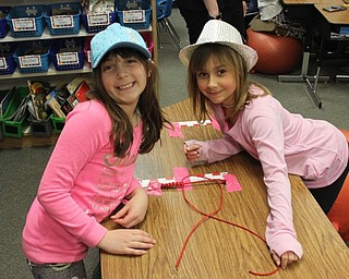 Neighbors | Abby Slanker.Two Hilltop Elementary School third-grade students in Marie Rupert’s class made paracord bracelets for their business Paracord Kids, which was the focus of an economics lesson, on March 14.