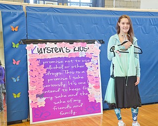 Kristina Kustelga, age 18, ECOT online student from Hubbard, holds her dress of choice after adding her name to Kyrsten's promise board at the Kyrsten's Kloset event at Roosevelt Elementary School in Hubbard, Ohio on March 24, 2018.

Photo by Scott Williams - The Vindicator