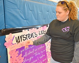 Taylor Pegg, age 17, from Hubbard, attaches her name to Kyrsten's promise board after selecting a dress at the Kyrsten's Kloset event at Roosevelt Elementary School in Hubbard, Ohio on March 24, 2018.

Photo by Scott Williams - The Vindicator