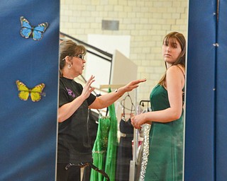 Kathy Minniti, left, a volunteer from Lowellville, makes some adjustments to Alexa Kurimski, age 16, from Canfield, who came to try on dresses at the Kyrsten's Kloset event at Roosevelt Elementary School in Hubbard, Ohio on March 24, 2018.

Photo by Scott Williams - The Vindicator