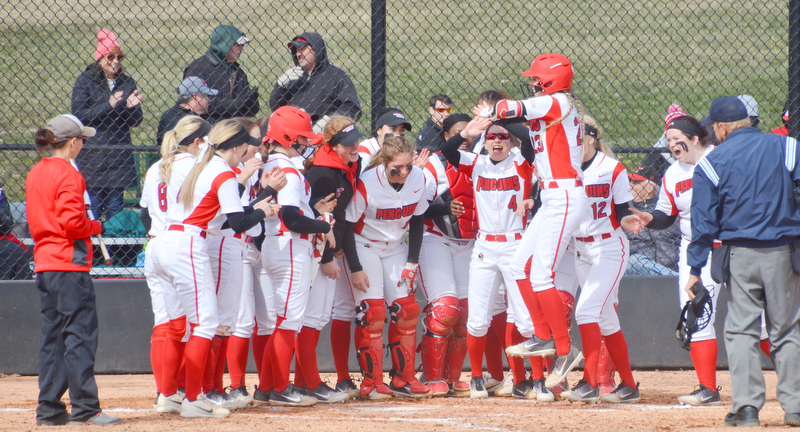 Lexi Zappitelli, #23, leaps in the air as she's about to be mobbed by her teammates after hitting one over the fence during game two against Indiana University-Purdue University Indianapolis March 24, 2018 at the Covelli Sports Complex at Youngstown State University.

Photo by Scott Williams - The Vindicator.