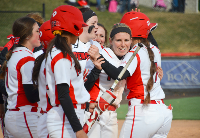 Kelly Thompson-Cappadocio, #7, gets a hug from Alexis Roach, #8, and smiles from her teammates after hitting enough runners in to call the game under mercy rule during game two against Indiana University-Purdue University Indianapolis March 24, 2018 at the Covelli Sports Complex at Youngstown State University.

Photo by Scott Williams - The Vindicator
