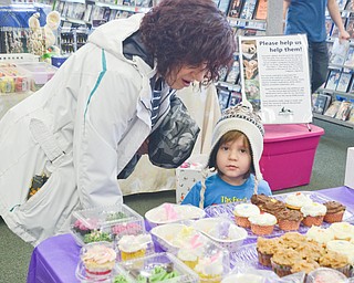 Janet Vankovich, left, and her grandson Mason Collingwood, age 3, look over the baked goods table at Legacy Dog Rescue and F5RS - Frisky Ferrets, Fuzzies, and Feathered Friends' event called "Somebunny to Love" at Family Video in Austintown on Sunday March 25, 2018.  

Photo by Scott Williams - The Vindicator 