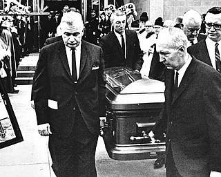 Pallbearers and funeral directors prepare to place the casket containing the body of Bishop Walsh, shepherd of nearly 300,000 Roman Catholics in the six-county Diocese of Youngstown, into the hearse for the trip from cathedral to Calvary Cemetery, which final rites were offered by Bishop Malone.  Carrying the bronze coffin are (left to right) James P. Griffin, steelworkers union leader; John E. Fox, president of the Fox Funeral Home; William Towell of Canton and Atty. Robert M. Murphy of Youngstown, pallbearers, and Joseph Vaschak, owner of the Vaschak Funeral Home.

Photo taken March 23, 1968.

Photo by Paul R. Schell.