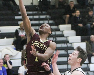 William D. Lewis The vindicator  Liberty's Dra Rushton(1) goes for 2 past  Struthers Ryan Leonard(20) during Bubba action at Warren Harding.