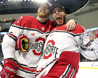 Ohio State forwards Luke Stork, left, and Christian Lampasso celebrate their 5-1 win over Denver in the NCAA college hockey Midwest Regional Final game Sunday in Allentown, Pa. Stork is a former Youngstown Phantom.