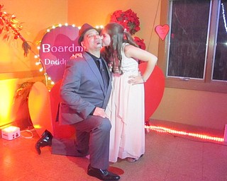 Neighbors | Zack Shively.Boardman Park's Father Daughter Dance had three photo areas, including a professional photo station. Pictured, Daniel Boyadich posed with his daughter Jadalyn Hollobaugh in front of a heart display.