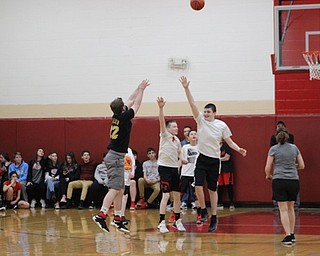 Neighbors | Abby Slanker.Members of the Canfield Village Middle School seventh-grade boys basketball team tried to block a shot of a member of the staff team on March 9.