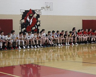 Neighbors | Abby Slanker.Members of the Canfield Village Middle School boys and girls basketball teams watch intently as their teammates battle the staff on March 9.