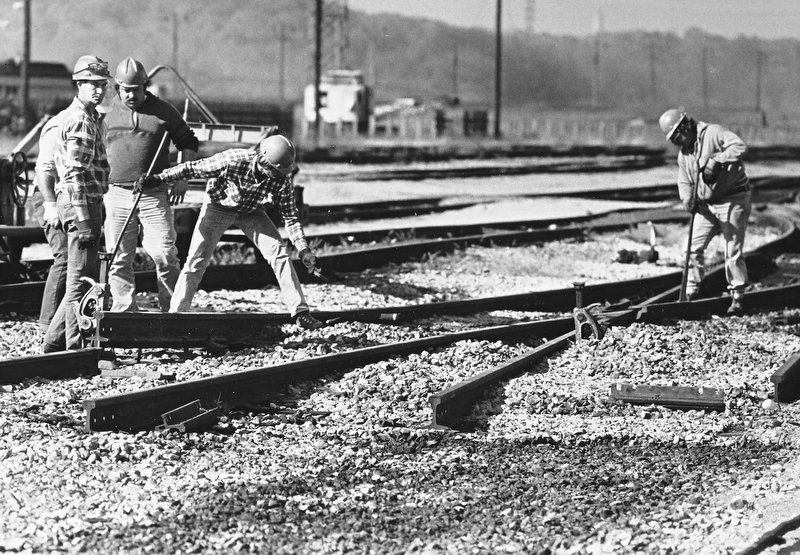 TRACKS REMOVED - A Conrail crew digs out railroad tracks at the Brier Hill Yard as part of the downtown rail relocation project.  Once Conrail has removed the tracks from the Brier Hill and Haselton yards, the city will take out those that run through the downtown.  Trains eventually will be rerouted to tracks that follow the Mahoning River...Photo by Robert K. Yosay - The Vindicator