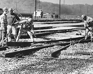TRACKS REMOVED - A Conrail crew digs out railroad tracks at the Brier Hill Yard as part of the downtown rail relocation project.  Once Conrail has removed the tracks from the Brier Hill and Haselton yards, the city will take out those that run through the downtown.  Trains eventually will be rerouted to tracks that follow the Mahoning River...Photo by Robert K. Yosay - The Vindicator