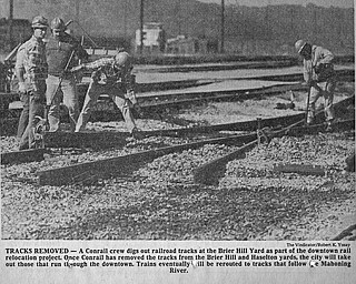 TRACKS REMOVED - A Conrail crew digs out railroad tracks at the Brier Hill Yard as part of the downtown rail relocation project.  Once Conrail has removed the tracks from the Brier Hill and Haselton yards, the city will take out those that run through the downtown.  Trains eventually will be rerouted to tracks that follow the Mahoning River...Photo by Robert K. Yosay - The Vindicator