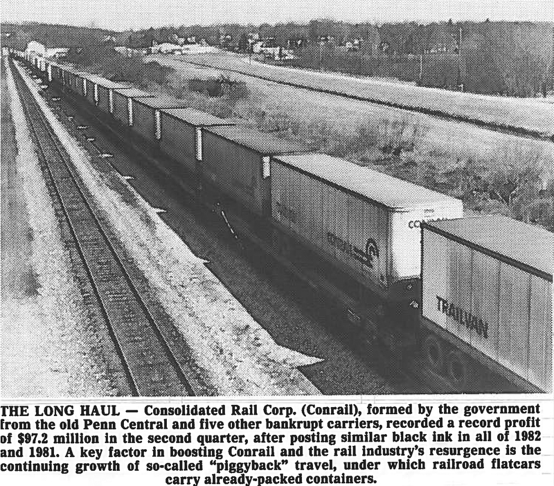 ONE THE (RAIL)ROAD AGAIN - Perhaps a sign of an economic turnaround, a long line of loaded Conrail Trailvans head west past Leetonia, which can be seen in the background...Photo by Edward A. Shuba - The Vindicator...THE LONG HAUL - Consolidated Rail Corp. (Conrail), formed by the government from the old Penn Central and five other bankrupt carriers, recorded profit of $97.2 million in the second quarter, after posting similar black ink in all of 1982 and 1981.  A key factor in boosting Conrail and the rail industry's resurgence is the continuing growth of so-called"piggyback" travel, under which railroad flatcars carry already-packed containers.  Aug 14-83...Economic recovery on the road. Loaded trailvans going west. Leetonia in background...Photo taken April 4, 1983...Photo by Edward A. Shuba - The Vindicator