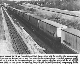 ONE THE (RAIL)ROAD AGAIN - Perhaps a sign of an economic turnaround, a long line of loaded Conrail Trailvans head west past Leetonia, which can be seen in the background...Photo by Edward A. Shuba - The Vindicator...THE LONG HAUL - Consolidated Rail Corp. (Conrail), formed by the government from the old Penn Central and five other bankrupt carriers, recorded profit of $97.2 million in the second quarter, after posting similar black ink in all of 1982 and 1981.  A key factor in boosting Conrail and the rail industry's resurgence is the continuing growth of so-called"piggyback" travel, under which railroad flatcars carry already-packed containers.  Aug 14-83...Economic recovery on the road. Loaded trailvans going west. Leetonia in background...Photo taken April 4, 1983...Photo by Edward A. Shuba - The Vindicator