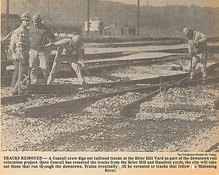 TRACKS REMOVED - A Conrail crew digs out railroad tracks at the Brier Hill Yard as part of the downtown rail relocation project.  Once Conrail has removed the tracks from the Brier Hill and Haselton yards, the city will take out those that run through the downtown.  Trains eventually will be rerouted to tracks that follow the Mahoning River...Photo by Robert K. Yosay - The Vindicator
