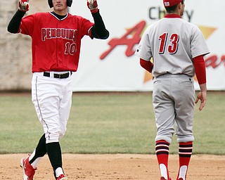 William D. Lewis The Vindicator YSU's Cody Dennis (10) reacts after hitting a double during 3-30-18 game at Eastwood. At right is UIC's Ryan Lin-Peistrup.
