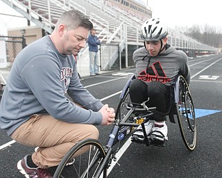 William D. Lewis The Vindicator   Micah Beckwith, Boardman 9th grader competes in track from a wheel chair. He is shown talking with his coach John Phillips.