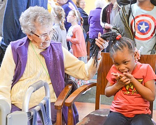 Helen Karash, left, 97, plays with Laryan Morris's, 5, hair at the Marian Assisted Living Center at Mercy's Assumption Village campus in North Lima on Saturday March 31, 2018. Morris attended the event with her mom Laqualyn Morris of Youngstown.

Photo by Scott Williams - The Vindicator.