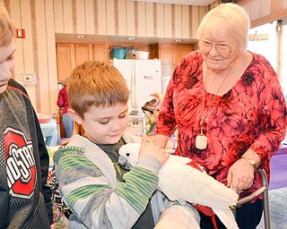 Dakota Duncan, 7, of North Lima, holds Nick Carano's therapy bird Ouija as brother Caleb Duncan and Great Grandma Eunice Lucyk watch on at the Marian Assisted Living Center at Mercy's Assumption Village campus in North Lima on Saturday March 31, 2018.

Photo by Scott Williams - The Vindicator