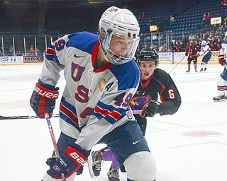 Max Ellis, #6, of the Youngstown Phantoms is moments away from slamming Matthew Boldy, #49, from Team USA, up against the glass at the Phantoms vs. Team USA game at the Covelli Centre on March 31, 2018...Photo by Scott Williams Ð The Vindicator..