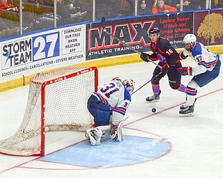 Cameron Rowe, #31, from Team USA barely blocks off Matthew Barry, #26, from the Youngstown Phantoms' shot as Marshall Warren, #37, from Team USA pushes him away at the Phantoms vs. Team USA game at the Covelli Centre on March 31, 2018...Photo by Scott Williams Ð The Vindicator.