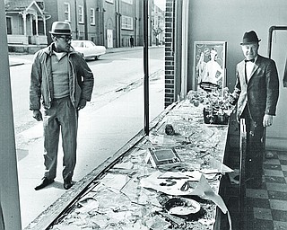 A cleaners at Hillman and Woodland in Youngstown assesses the damage to the store after riots erupted once the news spread the Martin Luther King had been assassinated.

Vindicator file photo