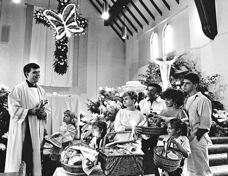 BLESS THESE BASKETS: After the long Lenten season, Catholics are celebrating the Resurrection with a feast.  The Rev. Michael Swierz of St. Rose Church, Girard, conducted the traditional blessing of Easter baskets Saturday.  Parishioners are, from left, Kim Nemkovich, and Jessica and Marilyn Brocious, all of Girard; the Palen Family of Niles, Marge, Ray, Denise, and Bryan; and Julia Bigowsky (foreground) of Girard...Photo by Robert K. Yosay - The Vindicator