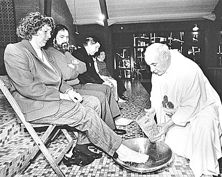 KEEPING TRADITION: The Pittsburgh Catholic Diocese allowed women to participate in the Holy Thursday foot-washing ritual yesterday after banning them a year ago.  The Rev. Norbert Campbell, pastor of St. Joseph the Worker Church in New Castle, washed the right foot of Mary Senko of New Castle last night.  Five other women and six men also participated in the ceremony.

Photo taken April 16, 1987.

Photo by Choo H. Ng - The Vindicator