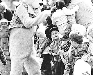 400 YOUNGSTERS HUNT EGGS HIDDEN BY THE EASTER BUNNY - The Easter Bunny brought smiles to some 400 wide-eyed youngsters ages 5 and under Tuesday during the Youngstown Park and Recreation Department's annual Easter Egg Hunt in Wick Park.  The goodies were donated by Gorant Candies.  Under the floppy ears is Anthony Linebaugh, a Youngstown Health Department employee. 

Photo by William D. Lewis - The Vindicator