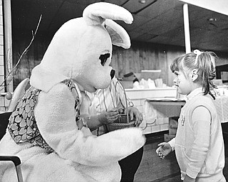 EASTER BUNNY IS HIT OF PARTY - Kristen Michaels, 3, of 433 E. Broadway, Girard, shook hands with the Easter Bunny during Girard's annual Easter party Saturday at the city gymnasium.  The party was co-sponsored by the juvenile division of the Girard Police Department and Costello's Candies. 

Photo taken April 11, 1987.  

Photo by Robert K. Yosay - The Vindicator