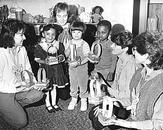 EASTER SWEETS - Children at the care center were given Easter baskets and each had a chance to find several eggs.  From left are: Linda Nye, chairman of the league's party committee; Brookes Johnson, Brenda Stock (a teacher at the center), Melissa Allen, Tony Madison, and league members Linda Ellashek and Anne Saraceno.  

Photo from March 26, 1986.