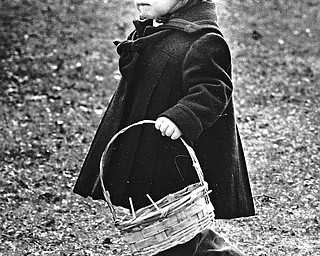 A TISKET, A TASKET - Angela Bata, the 2-year-old daughter of Mr. and Mrs. Thomas Bata of Hubbard came to the hunt with a basket large enough to carry home plenty of goodies.  

Photo taken March 25, 1986. 

Photo by William D. Lewis - The Vindicator.