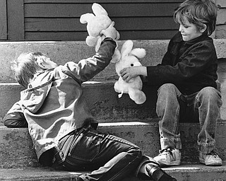 BOYS GET GOODIES DAY EARLY - The long-awaited day has finally arrived with area children waking to find Easter baskets filled with chocolate eggs and bunnies and maybe even a jelly bean or two.  Two area boys didn't wait until today to begin the festivities.  Scott Hays, 5, left and his big brother Patrick 7, of 1725 Midland St., Saturday spent some time on their front stoop playing with their Easter bunnies.  The boys were too busy playing with the bunnies to come up with names for them yet.

Photo taken March 29, 1986.

Photo by Patricia L. Fife - The Vindicator