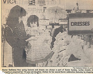 EASTER FASHIONS: New spring bonnets and dresses are always a part of Easter Sunday.  Lorilee Amedia of Youngstown prepared her 1.5-year-old daughter, Michal, for her second Easter celebration Saturday by shopping at the Hills Department Store in the Liberty Plaza.

Photo by William D. Lewis - The Vindicator 