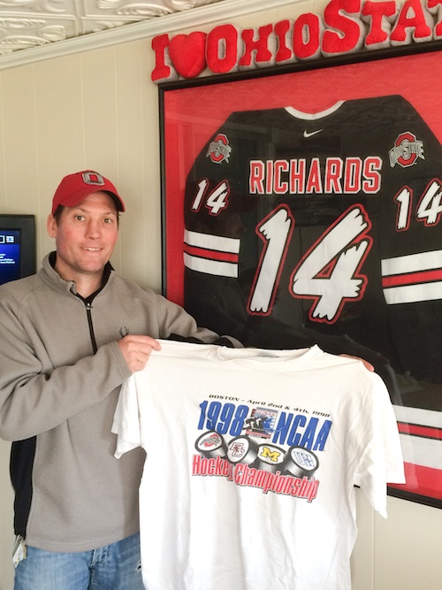 Chris Richards of Austintown holds his 1998 Frozen Four souvenir t-shirt in front of his framed Ohio State hockey jersey. Twenty years ago, Richards was the second-leading scorer on the Buckeyes’ last Frozen Four team.