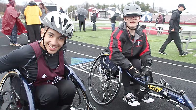 Micah Beckwith of Boardman, left, defeated Jake Hostetter of Canfield, in the first seated-athlete track and field race Tuesday at Boardman.