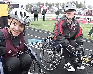 Micah Beckwith of Boardman, left, defeated Jake Hostetter of Canfield, in the first seated-athlete track and field race Tuesday at Boardman.
