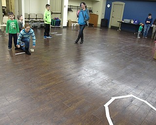Neighbors | Zack Shively.The Boardman library had a "Go for Gold" program on Feb. 15 where children played a series of games. The game pictured was a take on curling where the children rolled an apple into a designated area.