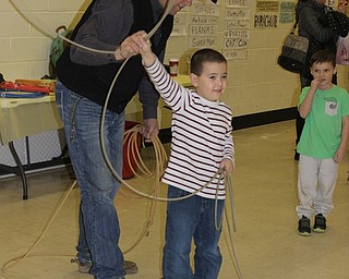Neighbors | Abby Slanker.Dave Zebrovious of Circle Z Bar Ranch in Fredonia, Pa., helped a Hilltop Elementary School student swing a lasso at the school’s annual K.I.S.S. event on March 8, which kicked off the school’s annual Wild Wild West themed book fair.