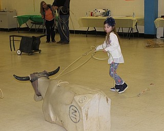 Neighbors | Abby Slanker.A Hilltop Elementary School first-grade student tried her hand at lassoing a cow dummy at the school’s annual K.I.S.S. event on March 8, which kicked off the school’s annual Wild Wild West themed book fair.