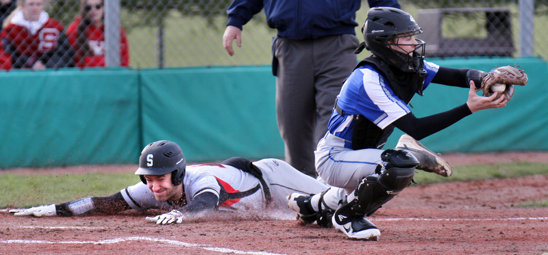 Struthers JD Hall(12) dives for the plate to score during 2nd inning as Poland catcher AndrewTesta(11) waits for the throw during 4-5-18 action at Cene.

William D. Lewis The Vindicator 