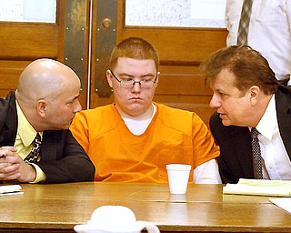 Jacob LaRosa listens to a discussion between his lawyers, David Rouzzo, left, and Matt Pentz, both of the Ohio Public Defender's Office, at LaRosa's sentencing hearing Thursday in Trumbull County Common Pleas Court.