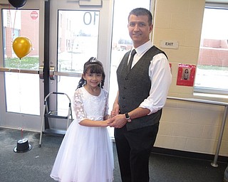 Neighbors | Zack Shively.Austintown Elementary School had a night for fathers and children on March 23. They had a dance, food and photo area. Pictured, Rick and Melicia Henry stood in line to get their picture taken.