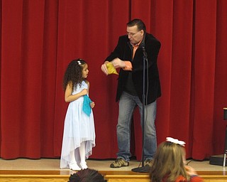 Neighbors | Zack Shively.The PTA invited magician Eric Thompson to the school to perform tricks while fathers and children ate and stood in line for their food. Pictured, Thompson performs a handkerchief trick with a student.