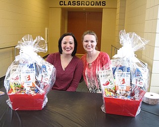 Neighbors | Zack Shively.Five hundred parents and students attended the father child night at Austintown Elementary School on March 23. Each family had the oppotunity to take a professional picture in the music room as well as place their name in a raffle for gift baskets. Pictured are Kristin Williamson and Angela Fossesca, who collected the parents tickets for the raffle.
