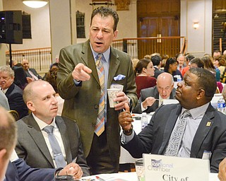 Daniel R. Yemma, standing, Mahoning County Treasurer, greets Youngstown Mayor Jamael Tito Brown and other department heads from the City of Youngstown at the Youngstown/Warren Regional Chamber of Commerce's "Good Morning, Youngstown" breakfast at Stambaugh Auditorium on Friday, April 6, 2018...Photo by Scott Williams - The Vindicator